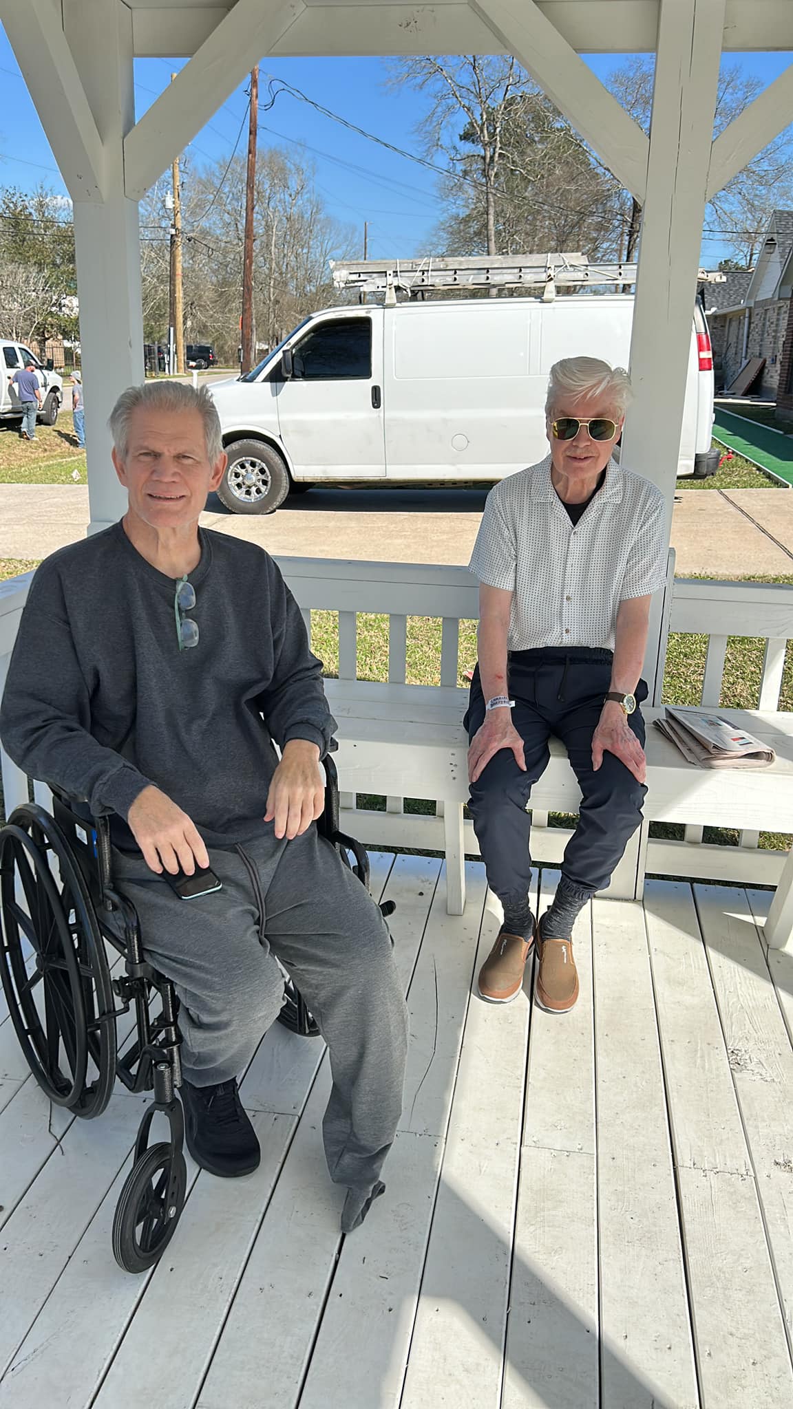 Two residents enjoying fresh air together on the porch